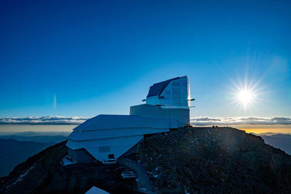 An observatory perched on a mountain peak at sunset.