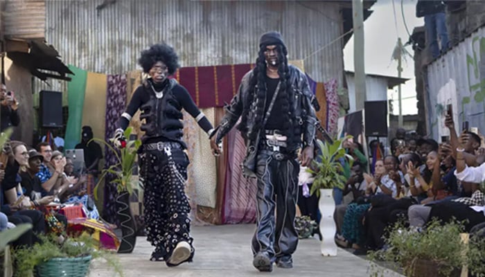 Models show off outfits created by local fashion designers specialising in upcycling discarded fabrics and garments from second-hand clothes markets. — AFP